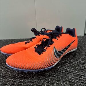 Nike Zoom Rival M 9 track and field spikes in a bright orange and blackened blue